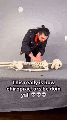 a man is laying on a skeleton on a bed and says this really is how chiropractors be doin yall