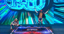 a wrestler named jetspeed is standing on a stage with his arms outstretched