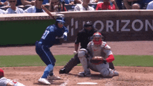 a baseball game is being played in front of a sign that says " find tickets at cubs "
