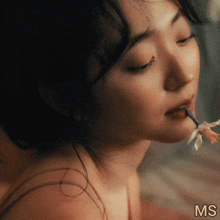 a close up of a woman 's face with the letters ms visible