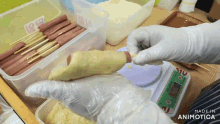 a person wearing white gloves is holding a piece of dough in front of a scale that says made in animotica