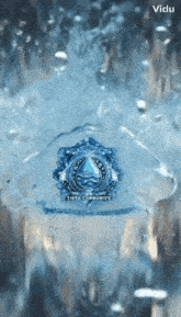 a ring with a water drop on it is floating in a glass of water