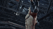 a man and a woman are fighting in a boxing ring with smoke coming out of it .