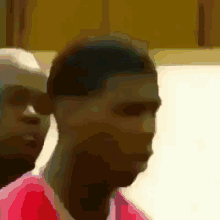 a blurry picture of a man with a red shirt