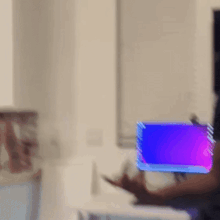 a blurry photo of a person standing in front of a computer screen