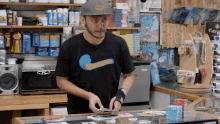 a man wearing a nike shirt is standing in front of a counter in a store