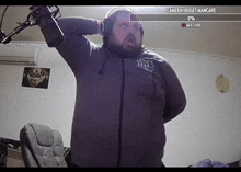 a man with a beard is wearing headphones and holding a microphone .