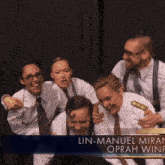 a group of people posing for a picture with the name lin-manuel miran on the bottom right