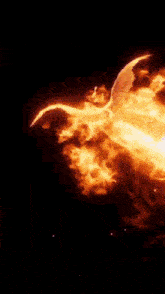 a statue of an angel is surrounded by flames and is flying through the air .