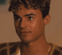 a close up of a young man 's face with his eyes closed