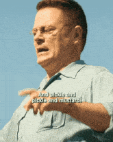 a man with glasses and a blue shirt says " and pickle and pickle and mustard "
