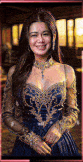 a woman in a blue and gold dress is smiling and looking at the camera