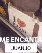 a sign that says i love juanjo with a red heart