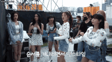 a group of girls are standing in front of a microphone with the words honeycam.org in the upper right corner