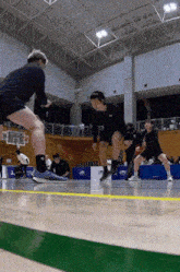 a group of people are playing a game of basketball in a gym sponsored by lms