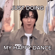 a young man is making a funny face and saying just doing my happy dance