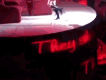 a person is dancing on a stage with the word they behind them