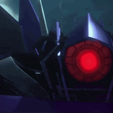 a close up of a purple robot with a red light