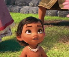 a little girl wearing a necklace with shells around her neck