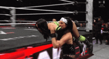 two women are wrestling in a ring with the letters n on the bottom of the screen