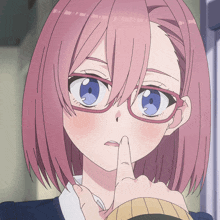 a girl with pink hair and blue eyes is holding her finger to her nose