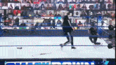 a wrestling match is being shown on a screen that says ' smackdown ' on it