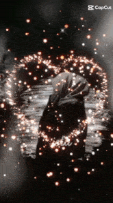 a black and white photo of a person surrounded by sparks with the caption capcut