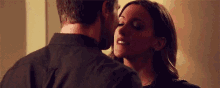 a man and a woman are kissing each other .