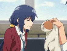 a girl in a red jacket and tie is petting a white and orange cat