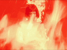 a woman is surrounded by flames and smoke