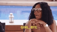 a woman wearing sunglasses and a watch is sitting in front of a pool and says girl bye .