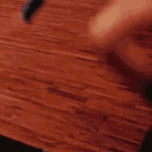 a person is standing on a wooden floor with their legs crossed .