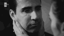 a woman touches a man 's face in a black and white photo that says tv