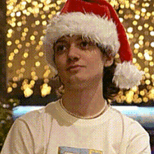 a man wearing a santa hat and a white t-shirt