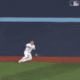 a baseball player with the number 5 on his jersey is doing a handstand