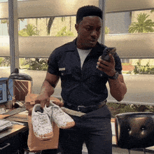 a man in a uniform holds a pair of white shoes
