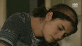 a close up of a woman 's face with hbo max in the corner