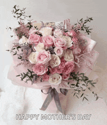 a bouquet of pink and white roses with the words happy mother 's day