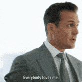 a man in a suit and tie says that everybody loves me