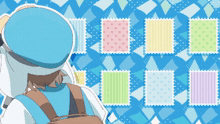 a person in a blue hat is looking at a wall of stamps