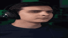 a man wearing headphones is looking at something