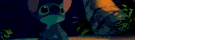 a cartoon character from the movie lilo and stitch is sitting in a dark room .