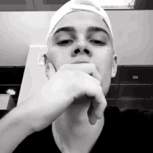a black and white photo of a man with the word em on the bottom left