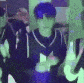 a man wearing sunglasses and a mask is dancing in a dark room .