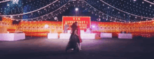 two people are dancing in front of a sign for vin university