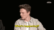 a man is making a funny face and says what 's happening .
