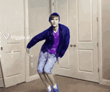 a young man in a blue jacket and purple shirt is dancing in a room with a sign that says viggle.ai on it