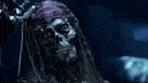 a skeleton with dreadlocks and a bandana on his head
