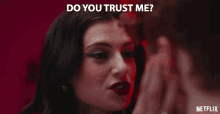 a woman is smiling with the words " do you trust me " behind her
