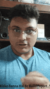 a man wearing glasses and a blue shirt with the words kisko banna hai bc build export written below him